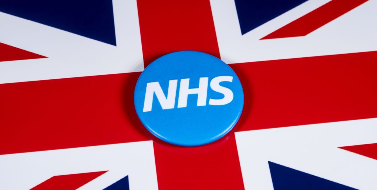 U.K. flag with button saying "NHS" on it.